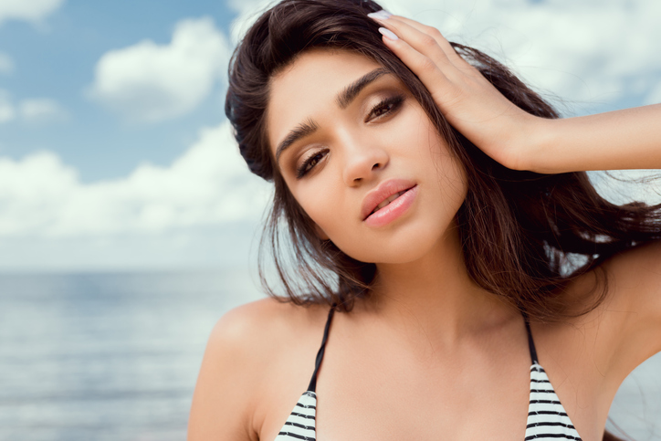 portrait of beautiful brunette girl in swimsuit