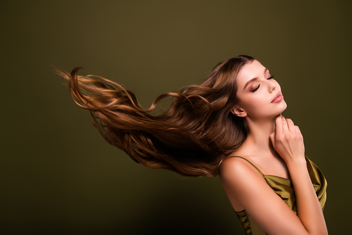 Photo of lovely elegant chic classy lady fluttering long healthy hair isolated on khaki color background