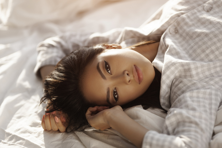 Asian Woman Lying on the Bed