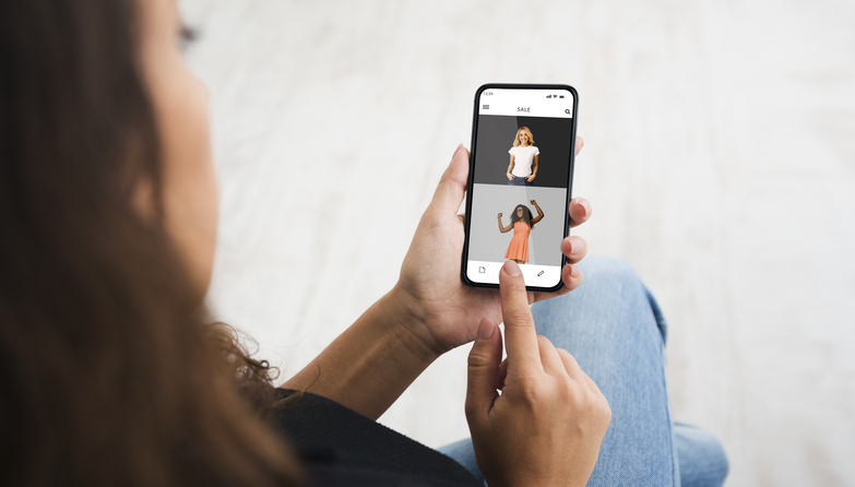 Woman using smartphone browsing online fashion store website